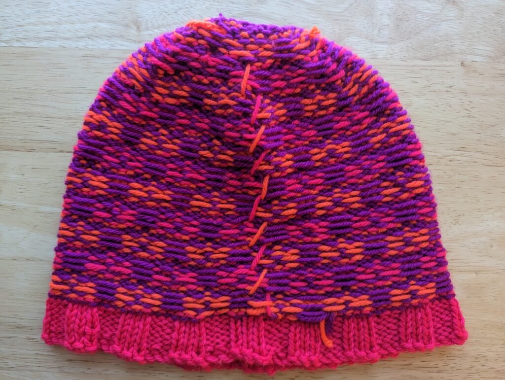 the inside of a pink brimmed and pink and orange alternating checkerboard block pattern with violet bordering.  The inside shows rather clean floats.